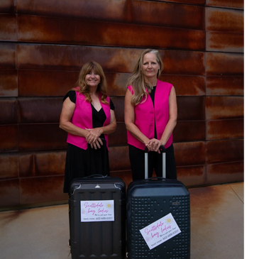 Two women wearing pink and black outfits