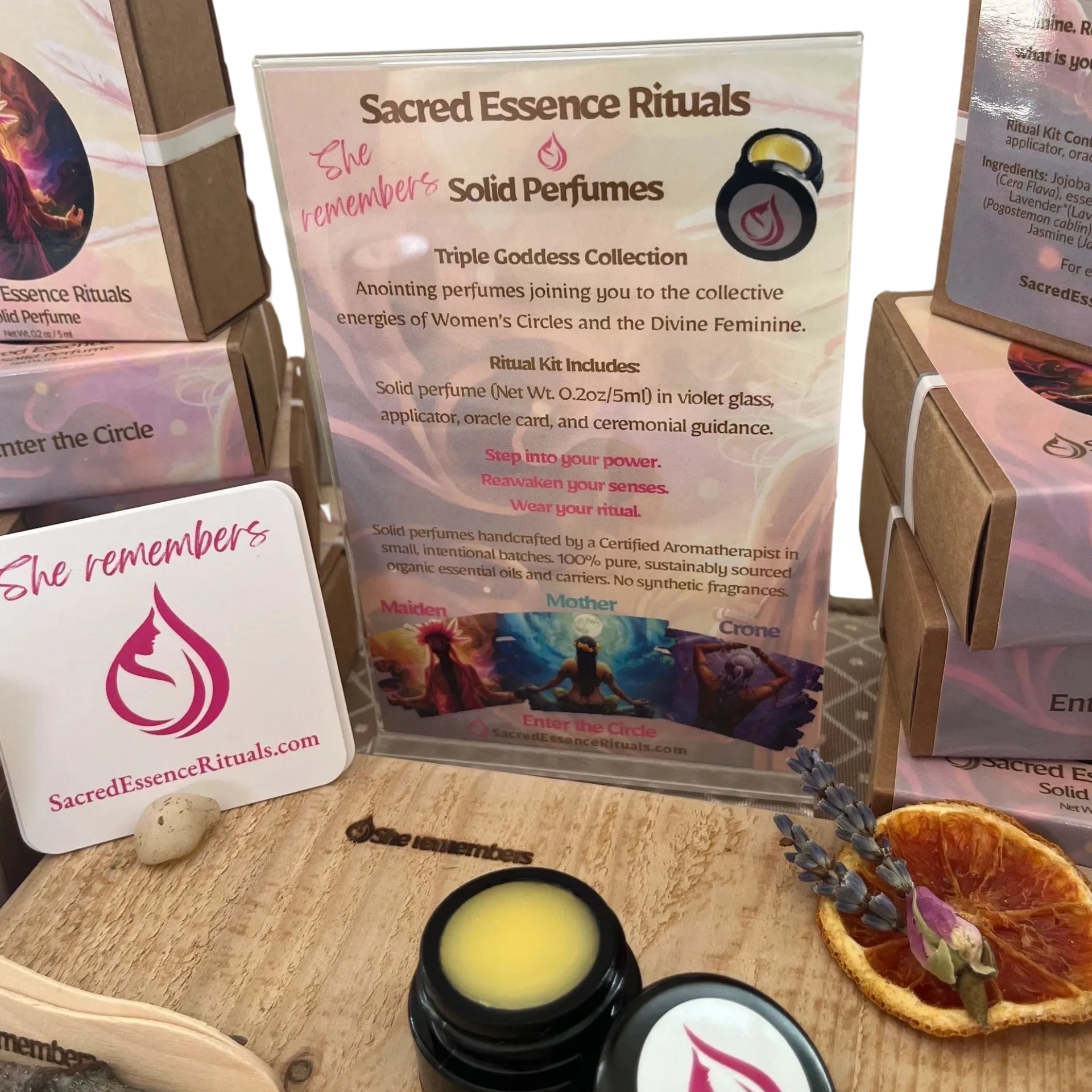 Display of boxes and sample of a solid perfume on a piece of wood with words She Remembers
