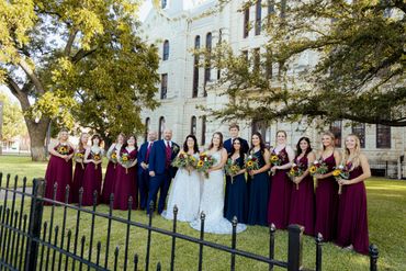 bridal party in front of a courthouse