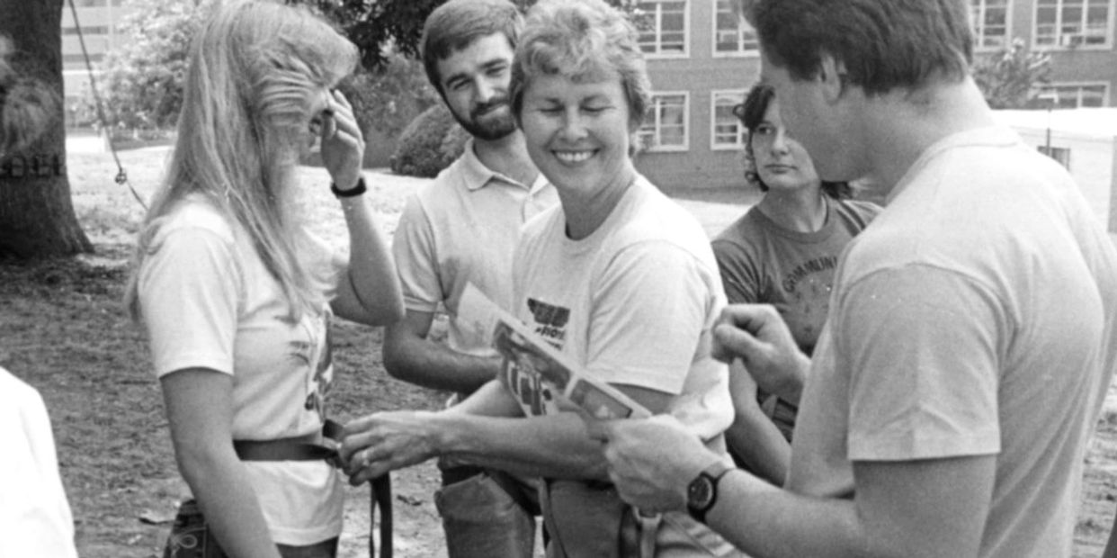 B/W Image of Jean Berube teaching at Gallaudet's rope course - She is surrounded by her students.