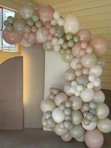 Elegant pastel balloon arch decoration indoors.