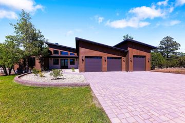 Modern house with slanted roofs and a three-car garage.
