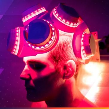 Person wearing a futuristic glowing helmet.