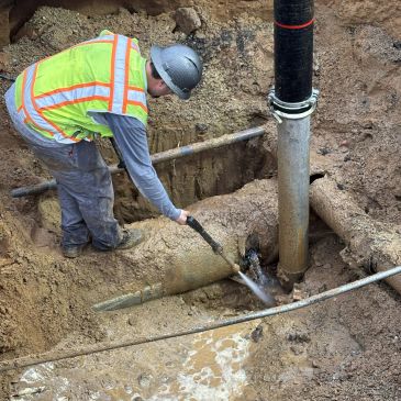 A worker hydro excavating.