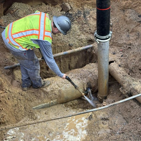 A worker hydro excavating.