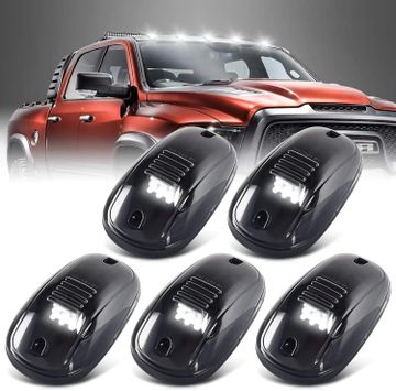 Five black LED roof lights for trucks with a red truck in the background.