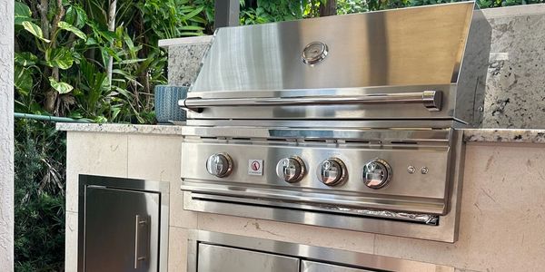 Modern stainless steel outdoor grill with control knobs.