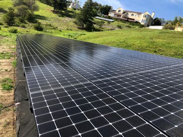 Image of hill-side solar panel installation on a residential property in California Project done by 