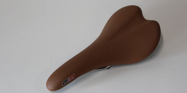 Brown bicycle seat against white background.