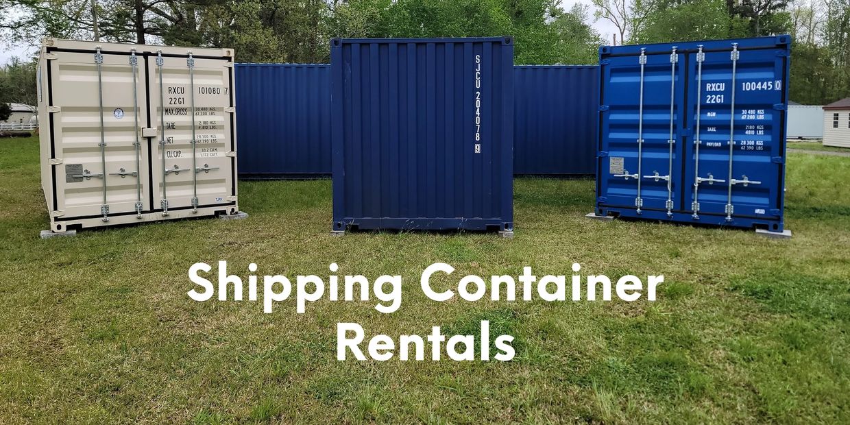 Three shipping containers in a grassy area on the Endless Storage Solutions sales lot.