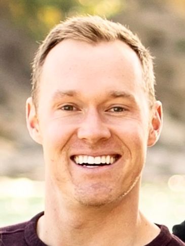 A Man With A Wide Grin On His Face