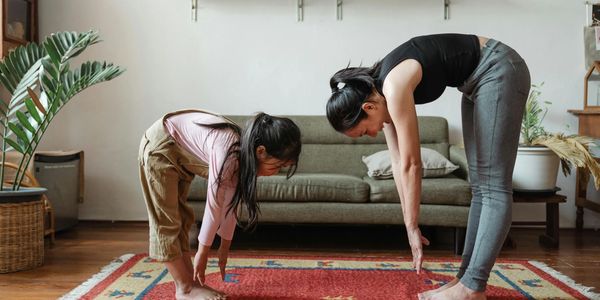 Mother and daughter exercising, representing AgileLife Wellness' family health and fitness coaching.