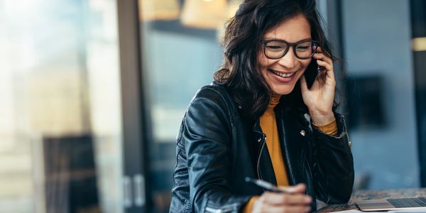 Happy client talking to accountant on phone