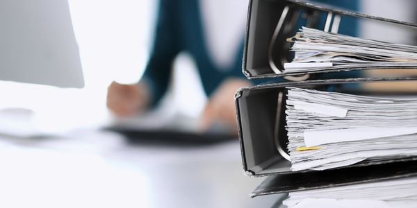 Paperwork piling up on desk