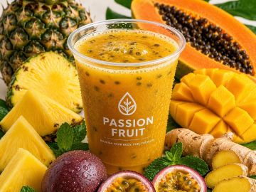 A fresh passion fruit juice surrounded by tropical fruits.