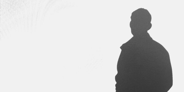 Silhouette of a person against a light background.