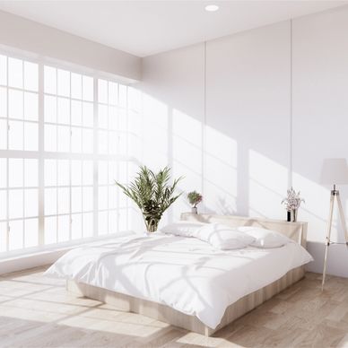 Bright, minimalist bedroom with large windows and cozy bed.