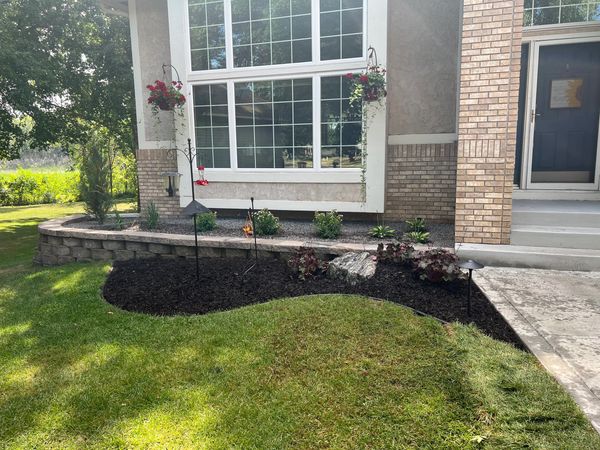 Minnesota front foundation landscape renovation with landscape block retaining wall and new sidewalk