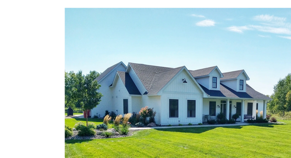 Residential landscape renovation with shrubs, trees, perennials, boulders, and decorative rock