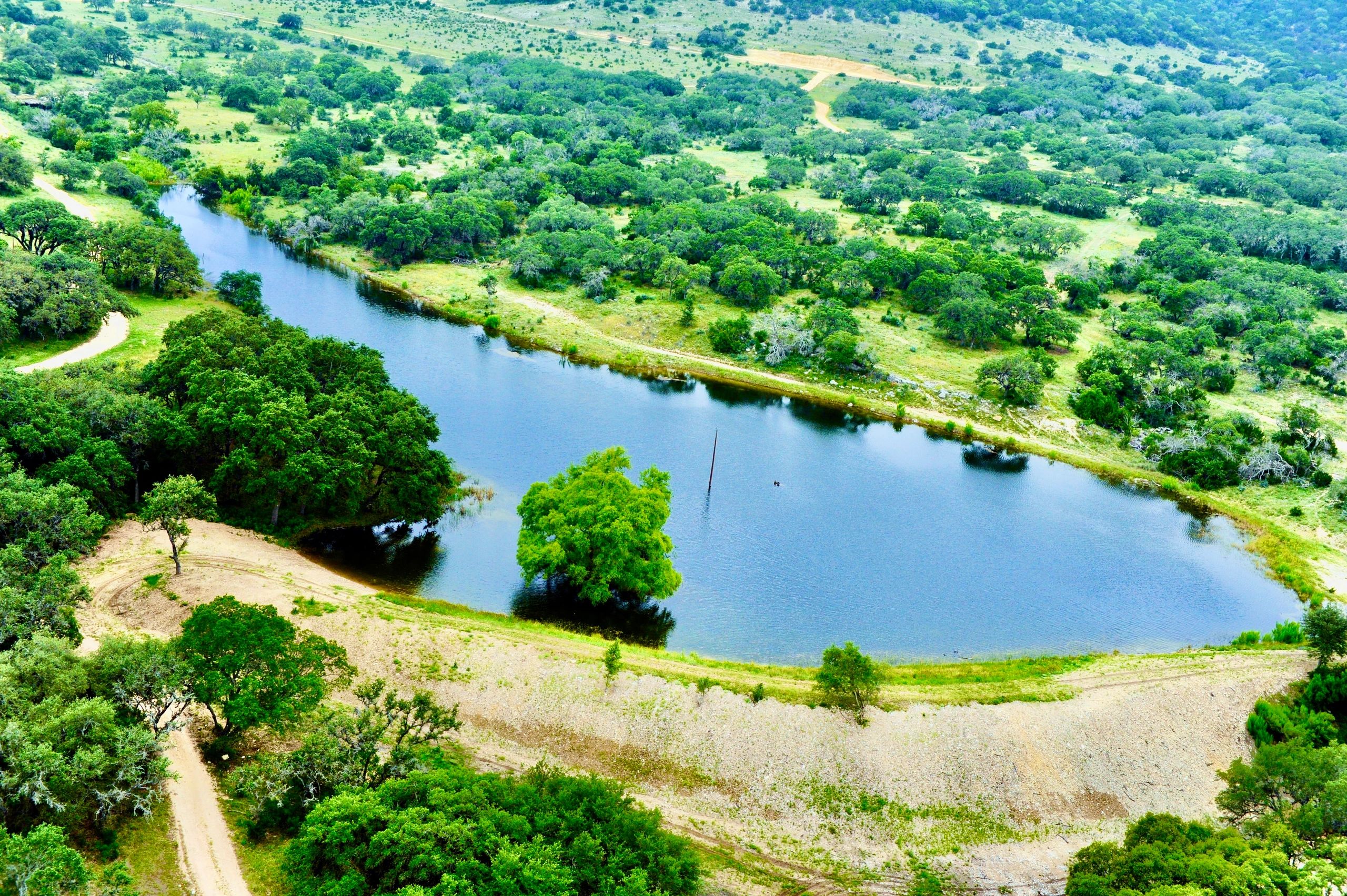 Large Pond surrounded by beautiful Oak trees. Build by 3R Sodbusters Inc. 