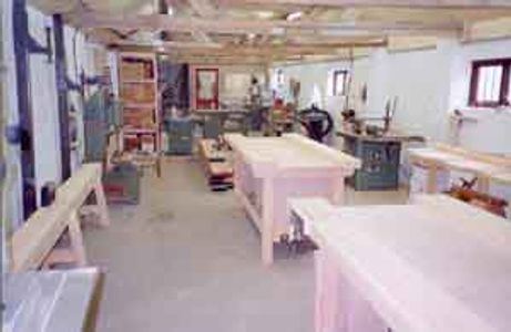 A woodworking workshop with tools and workbenches.