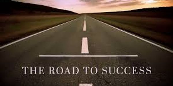 Photo of a road with a text overlay saying "The road to success"