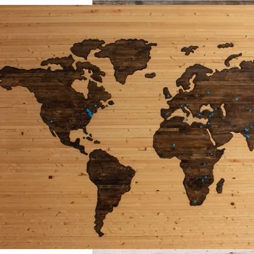 A map of the world lazer etched on a wooden board. We work with International Clients.