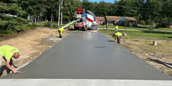 Concrete finishers working on driveway.