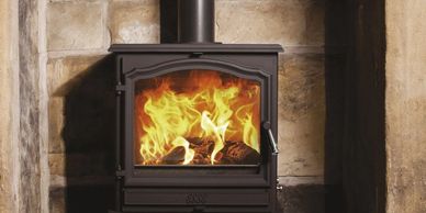 Black esse 700 freestanding multi fuel wood heater with large viewing glass door.