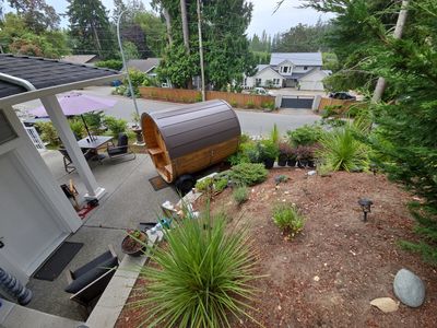 Landscaped residential yard in Nanaimo BC with garden beds, plants, mulch and outdoor living area