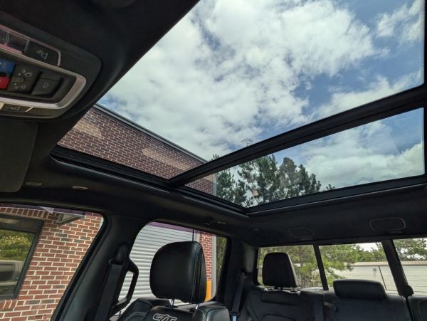 Interior view of a car with a panoramic sunroof.