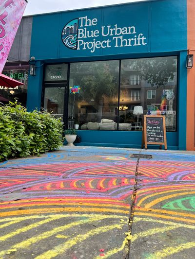 The Blue Urban Project Thrift storefront with colorful chalk art.