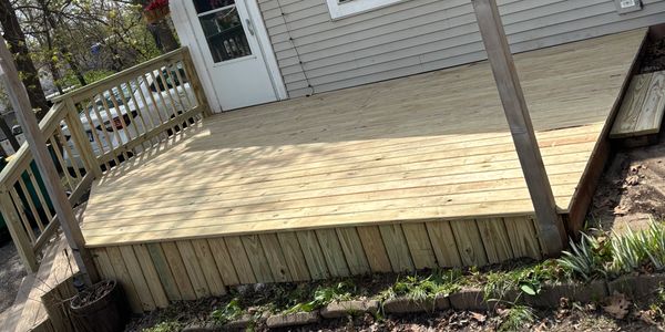 New wooden deck attached to a house.