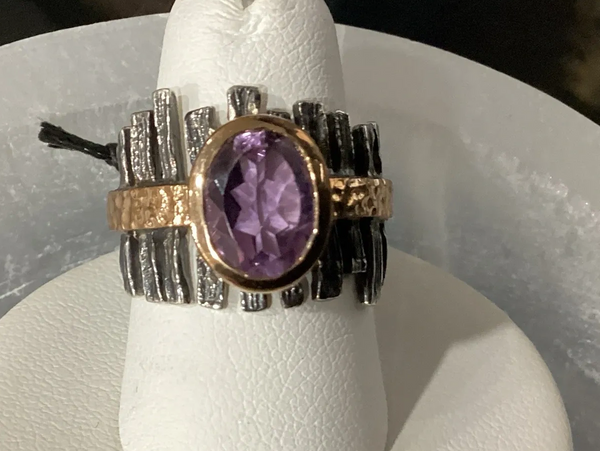 Oxidized sterling silver ring with bronze accents and a faceted amethyst gemstone centerpiece.