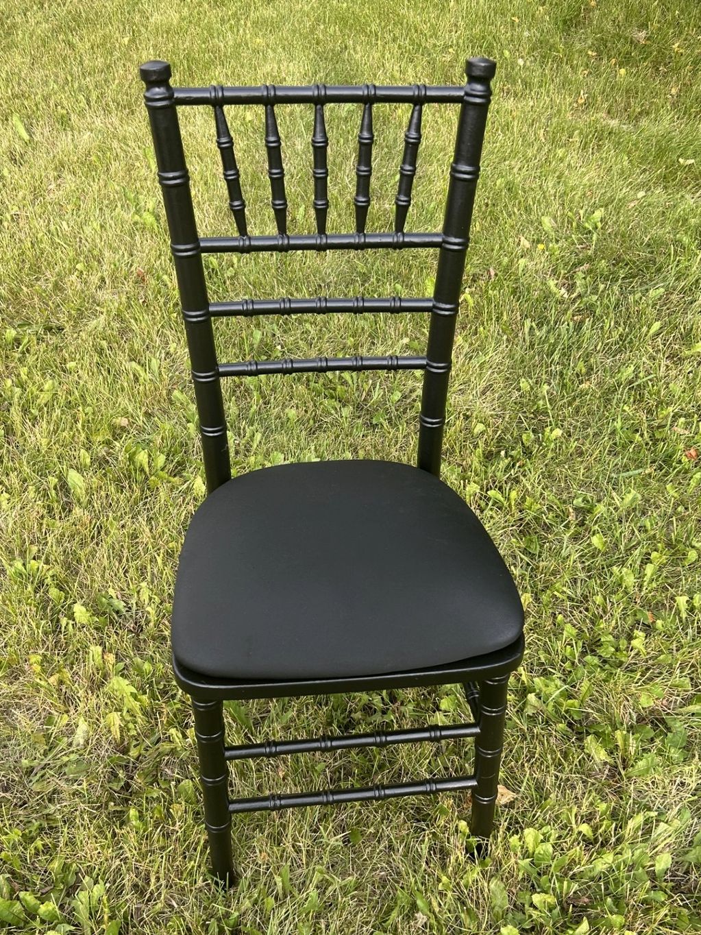 Black Chiavari chair with black cushion.