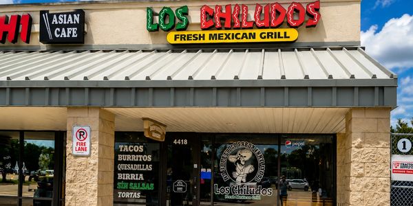 Exterior of Los Chiludos Fresh Mexican Grill with menu items listed.