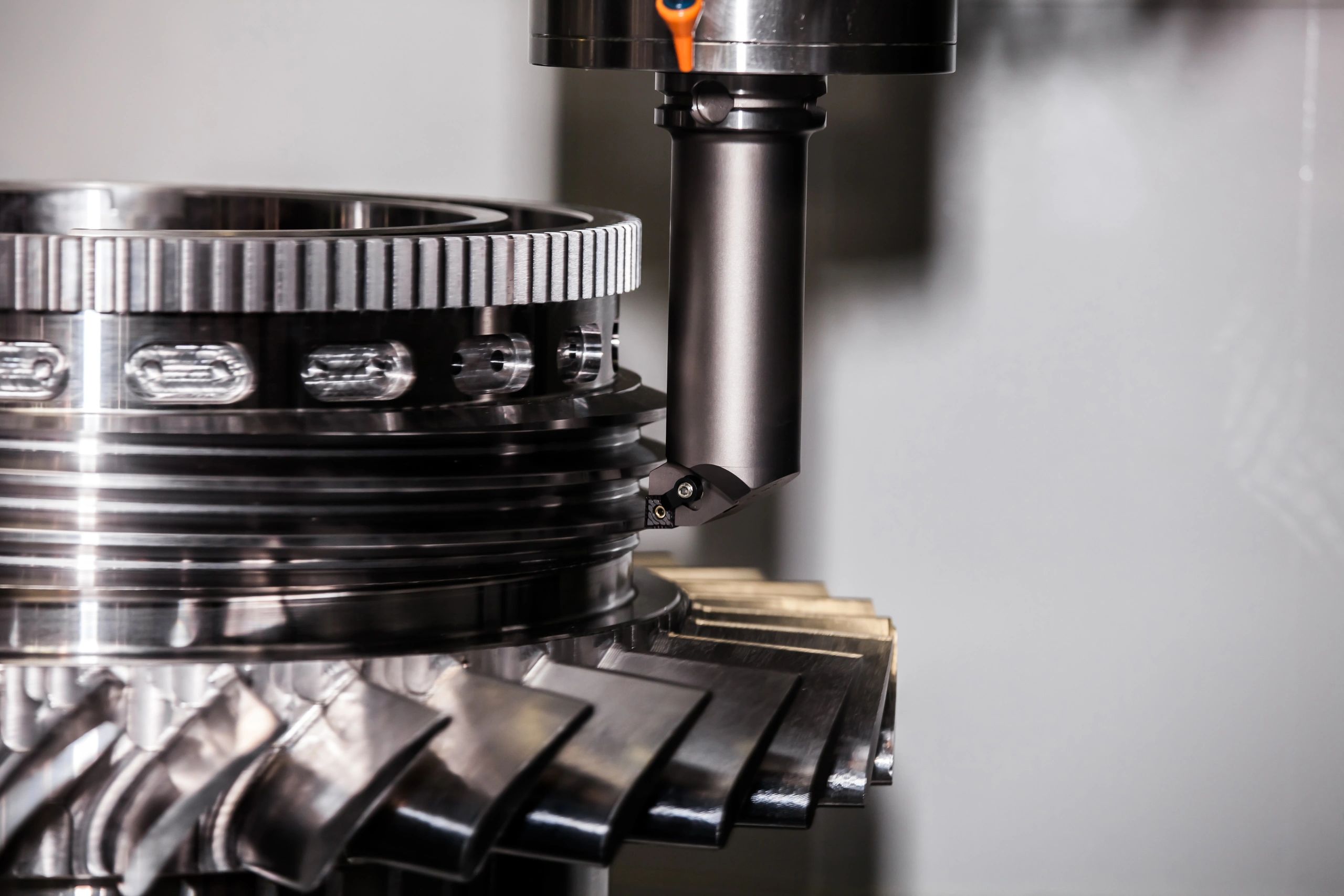 CNC machine precisely machining a large metal gear component.
