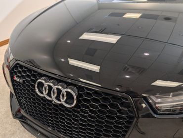 Close-up of a black Audi RS3 grille and hood.