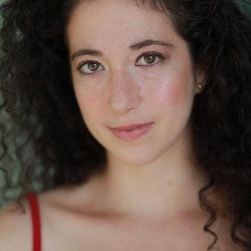 Young woman with curly hair and natural makeup.