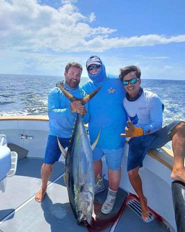 Happy fisherman poses with his catch onboard seawolf yellow fin tuna
