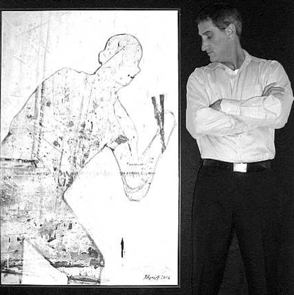 A photo of the artist Keith Theriot standing next to one of his paintings