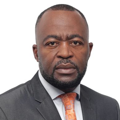 Professional man in a suit and orange tie with a serious expression.