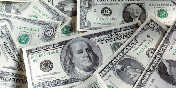 A pile of various US dollar bills including $1, $2, $50, and $100 notes.
