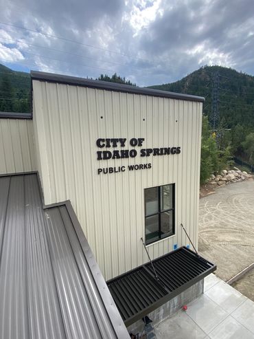 Exterior of the City of Idaho Springs Public Works building under a cloudy sky.