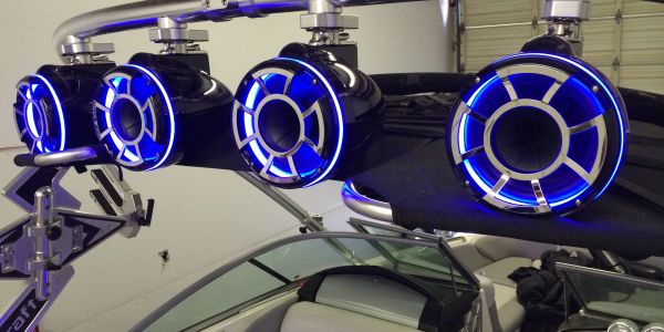 Blue illuminated speakers mounted on a boat.