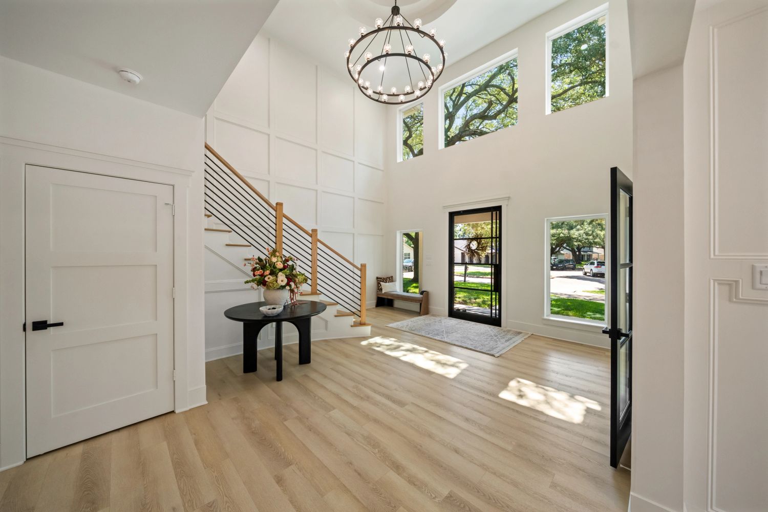 Bright modern entryway with high ceilings and large windows.