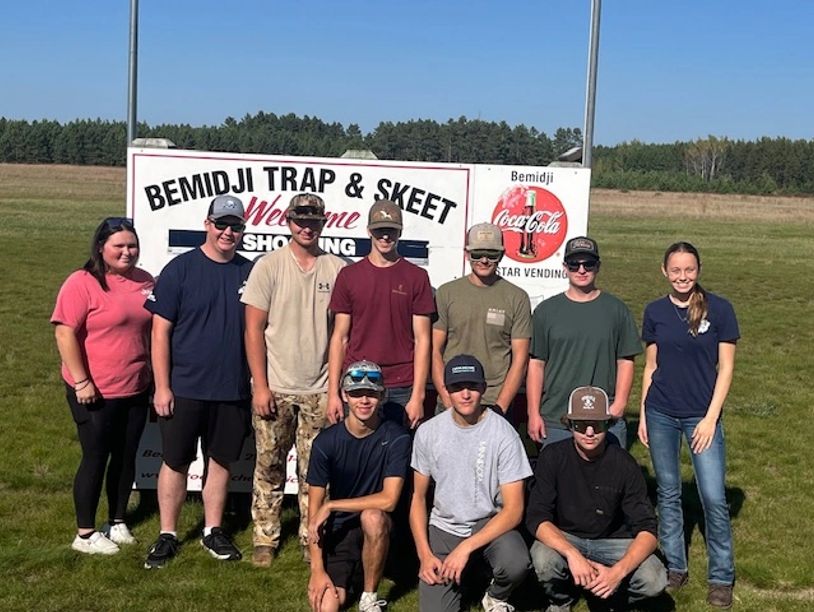 Group of young people posing at Bemidji Trap &amp; Skeet shooting range.