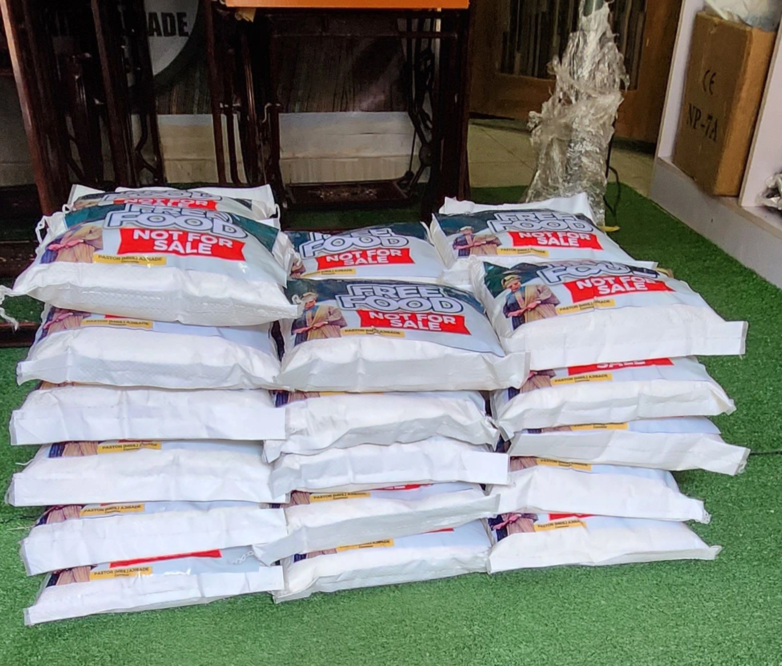 Stack of white bags labeled 'Free Food Not For Sale'.