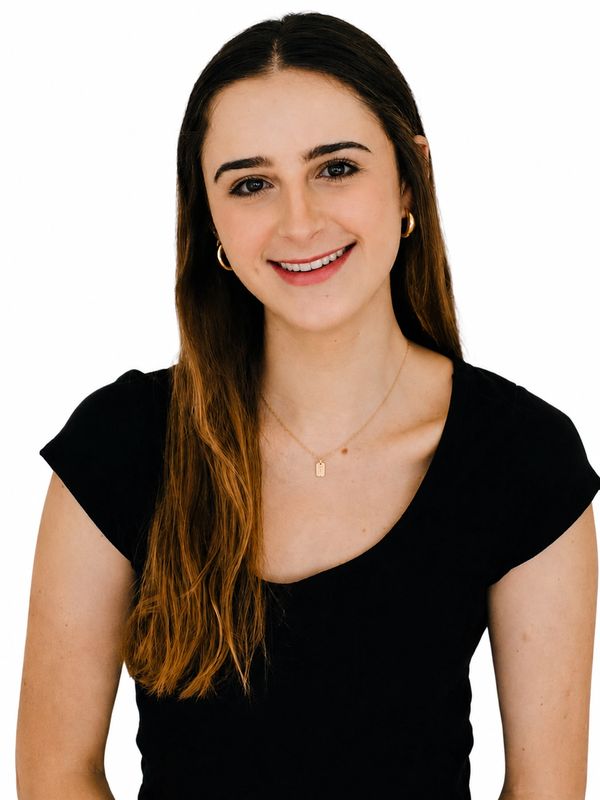 Smiling woman with long brown hair in a black top.