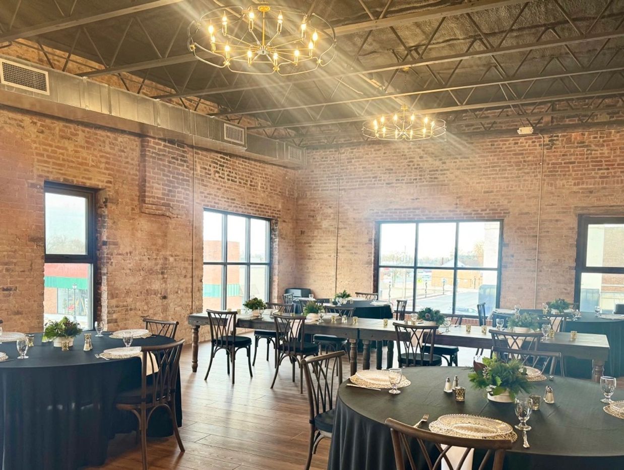 Charming dining room with exposed brick walls and elegant table settings.